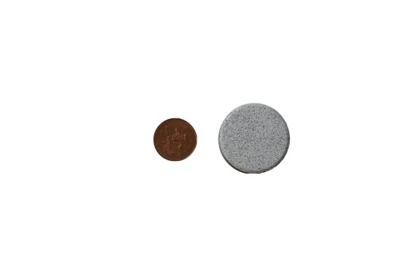 Slurry-Flo tablet size compared with 2 pence